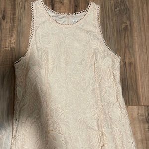 Peach colored lace sleeveless dress.